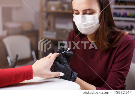 nails artist apply modeling gel polish with thin brush 45982144