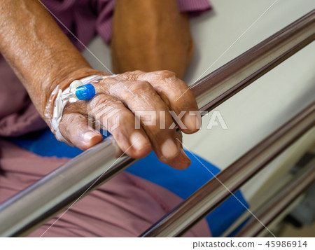 Close up hand patient elderly man hand with saline 45986914