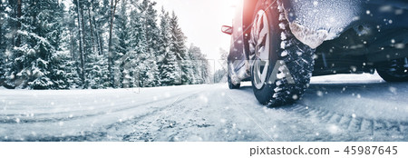 Closeup of car tires in winter on the road Closeup of car tires in winter on the road 45987645