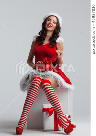 Girl unwrapping christmas present 45987830