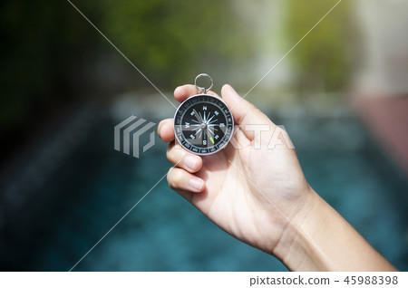 Hand holding compass 45988398
