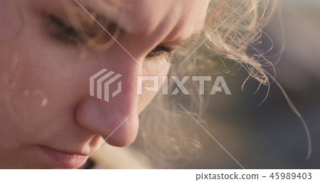 young female closeup portrait sitting on a seashore with thoughtful look young female closeup portrait sitting on a seashore with thoughtful look 45989403