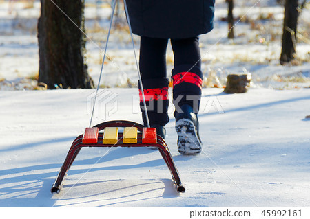 Child pulls sled broke snow snow in winter 45992161