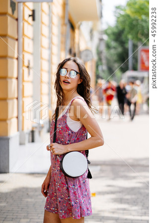 Girl posing for the camera with a female bag 45992238