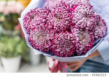 Big luxury bright bouquet in the hands of a cute girl. Bunch of garden purple and violet 45992523