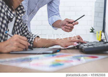 Two colleagues creative graphic designer working on color select Two colleagues creative graphic designer working on color select 45992808