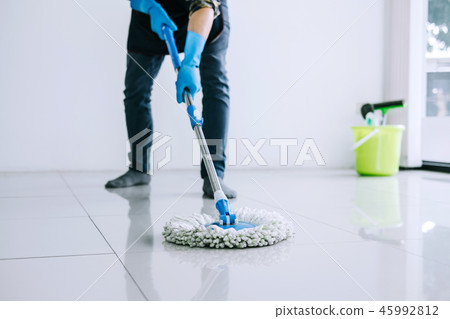 Husband housekeeping and cleaning concept, Happy young man in bl 45992812