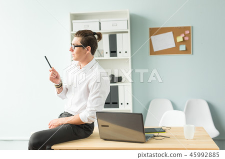 Handsome businessman having fun in the office Handsome businessman having fun in the office 45992885
