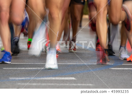 Runner legs front view in blurred motion Runner legs front view in blurred motion 45993235