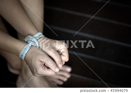 Closeup woman hands were tied with a rope Closeup woman hands were tied with a rope 45994070