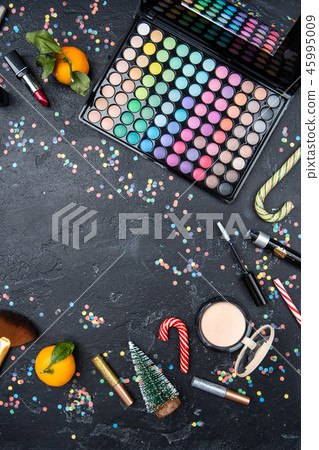 Photo from above of accessories for makeup artist, mandarin, Christmas fir, sugar cane Photo from above of accessories for makeup artist, mandarin, Christmas fir, sugar cane 45995009