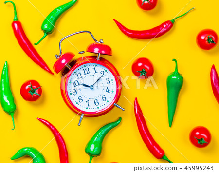 Chili pepper with tomatoes and alarm clock 45995243