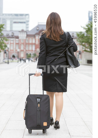 Young woman in a suit wearing a carry bag and walks towards Tokyo Station 45996510