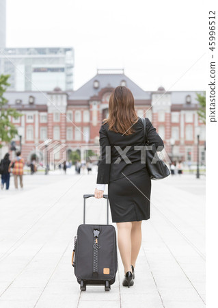 Young woman in a suit wearing a carry bag and walks towards Tokyo Station 45996512