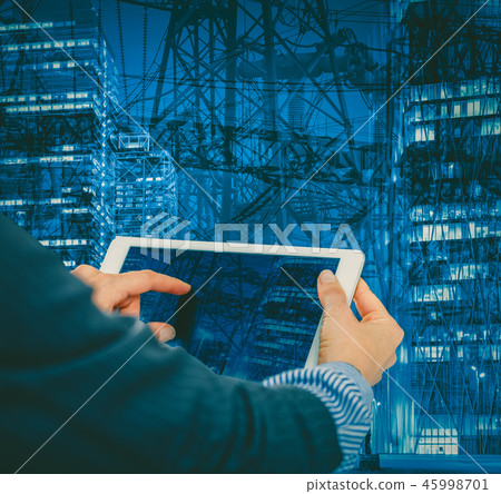 Female hands with tablet on industrial background 45998701