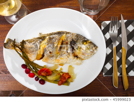 Top view of baked dorada with vegetable garnish Top view of baked dorada with vegetable garnish 45999023