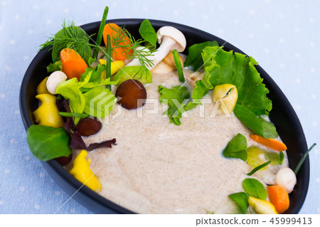 Mushroom cream soup boiled with honey fungus, served with vegetables Mushroom cream soup boiled with honey fungus, served with vegetables 45999413