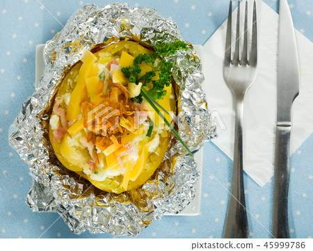Top view of potatoes baked in foil with stuffing 45999786