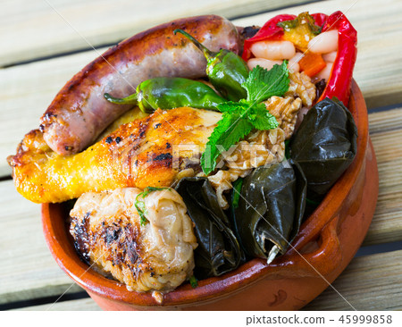 Kapama with grilled sausage, grape rolls, stuffed pepper and fried chicken Kapama with grilled sausage, grape rolls, stuffed pepper and fried chicken 45999858