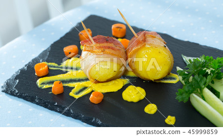 Baked potatoes in bacon with mustard cheese sauce Baked potatoes in bacon with mustard cheese sauce 45999859