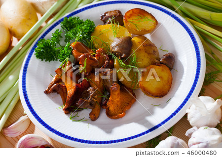 Top view of tasty fried chicken hearts, fried chanterelle mushrooms with potatoes Top view of tasty fried chicken hearts, fried chanterelle mushrooms with potatoes 46000480