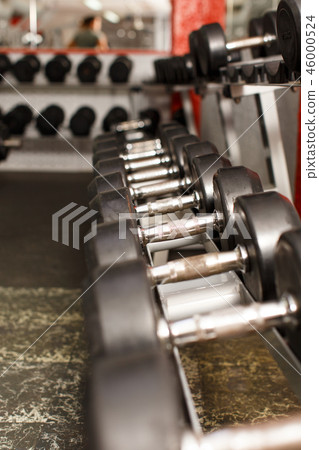 Sports equipment steel dumbbells on shelf 46000524