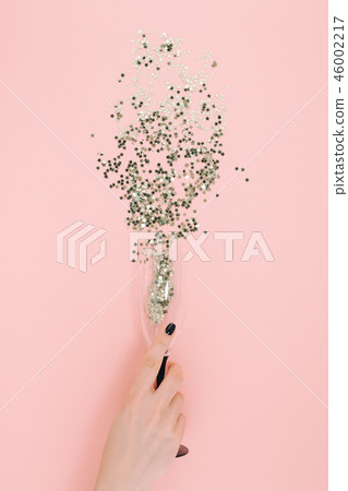Champagne glass poured out golden stars confetti Champagne glass poured out golden stars confetti 46002217