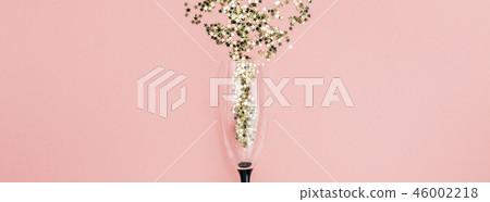 Champagne glass poured out golden stars confetti Champagne glass poured out golden stars confetti 46002218