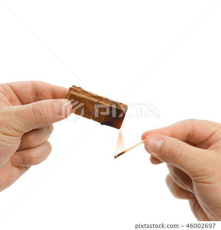 Hands of the man who burns solid firelighter 46002697