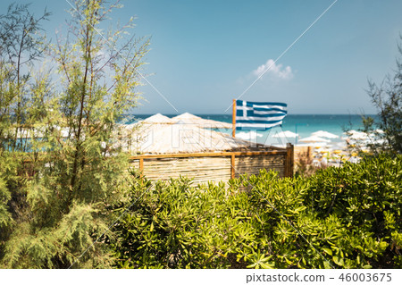 Defocussed Blurred Greek Flag And Tropical Beach Defocussed Blurred Greek Flag And Tropical Beach 46003675