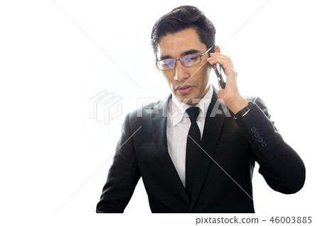 Asian businessman talking on cell phone isolated on white background. 46003885