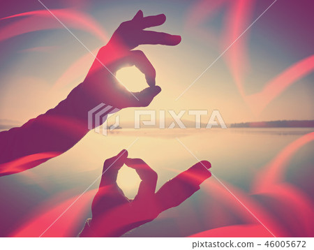 Filtered. Wrist makes ok sign is all right by sea 46005672