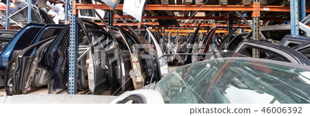 Auto parts market. On the ground are doors, bumpers and windshields. 46006392