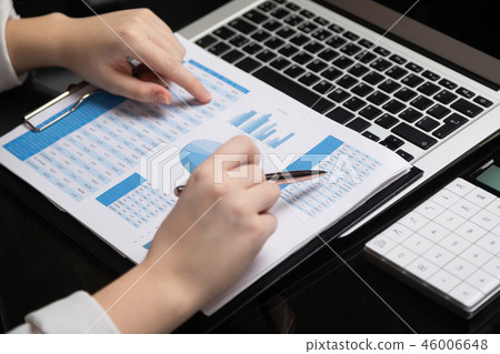 Female hands work with chart on a background of notebook Female hands work with chart on a background of notebook 46006648