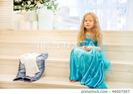 Cute girl sitting near Christmas Tree Cute girl sitting near Christmas Tree 46007867