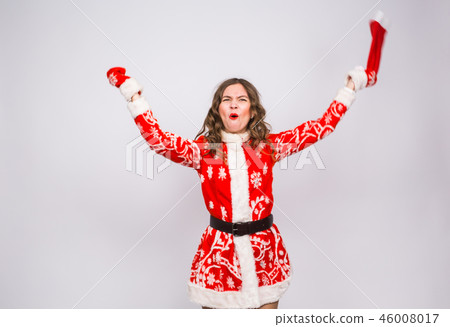 Christmas, emotions and holidays concept - excited shouting woman in santa costume on white 46008017