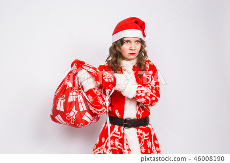 Christmas, emotions and people concept - angry woman in santa claus clothes holding presents on Christmas, emotions and people concept - angry woman in santa claus clothes holding presents on 46008190