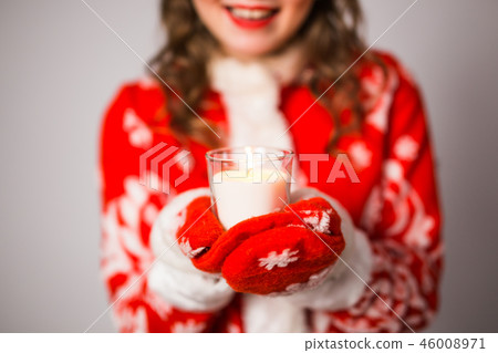 Christmas, celebration, people concept - Close up of Young charming woman in a Santa suit is holding Christmas, celebration, people concept - Close up of Young charming woman in a Santa suit is holding 46008971