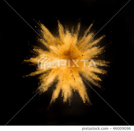 Golden powder explosion on black background. 46009096