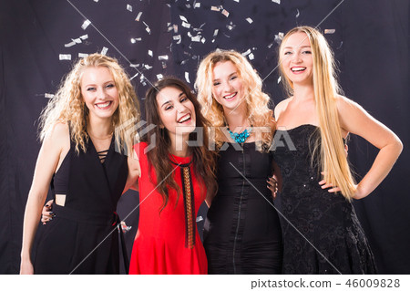 Party, holidays and new year eve concept - Group of cheerful joyful young woman standing and Party, holidays and new year eve concept - Group of cheerful joyful young woman standing and 46009828