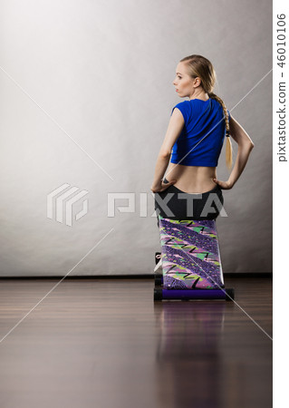 Woman training on bench for sit ups Woman training on bench for sit ups 46010106