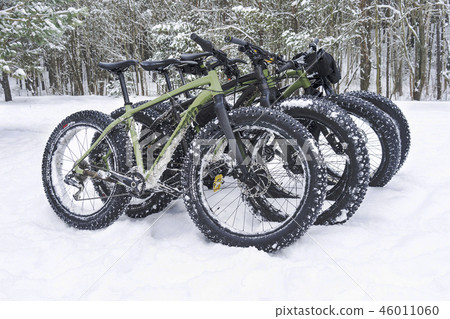 A fatbikes are standing in the woods in winter A fatbikes are standing in the woods in winter 46011060