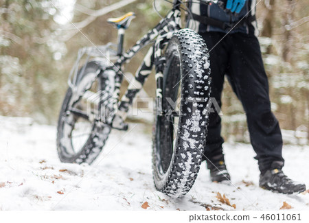 The guy keeps fatbike in the wood The guy keeps fatbike in the wood 46011061