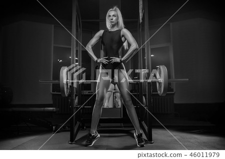 Young beautiful girl blond athlete bodybuilder doing a workout i 46011979