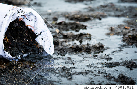 Garbage on the beach in white bag. Beach pollution 46013031