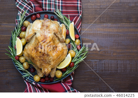 Roasted Chicken with potatoes and rosemary. Roasted Chicken with potatoes and rosemary. 46014225