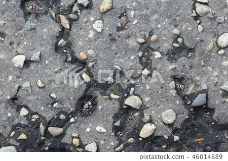 the texture of the old asphalt with pebbles and cracks 46014889