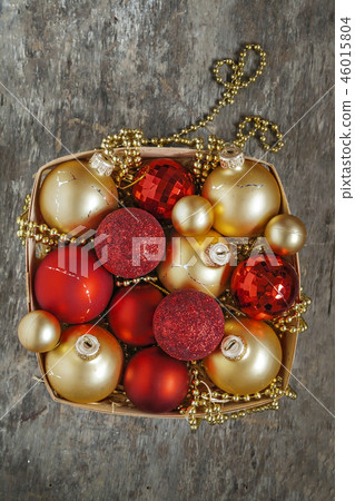 Christmas balls red and gold, beads lie in a woode Christmas balls red and gold, beads lie in a woode 46015804