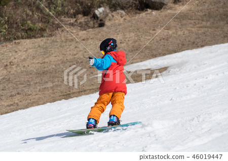 Elementary school student doing snowboarding Elementary school student doing snowboarding 46019447