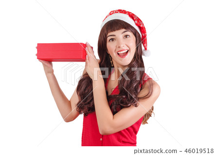Woman in santa hat holding Christmas gift box isolated on white with copyspace. Happy exited girl Woman in santa hat holding Christmas gift box isolated on white with copyspace. Happy exited girl 46019518